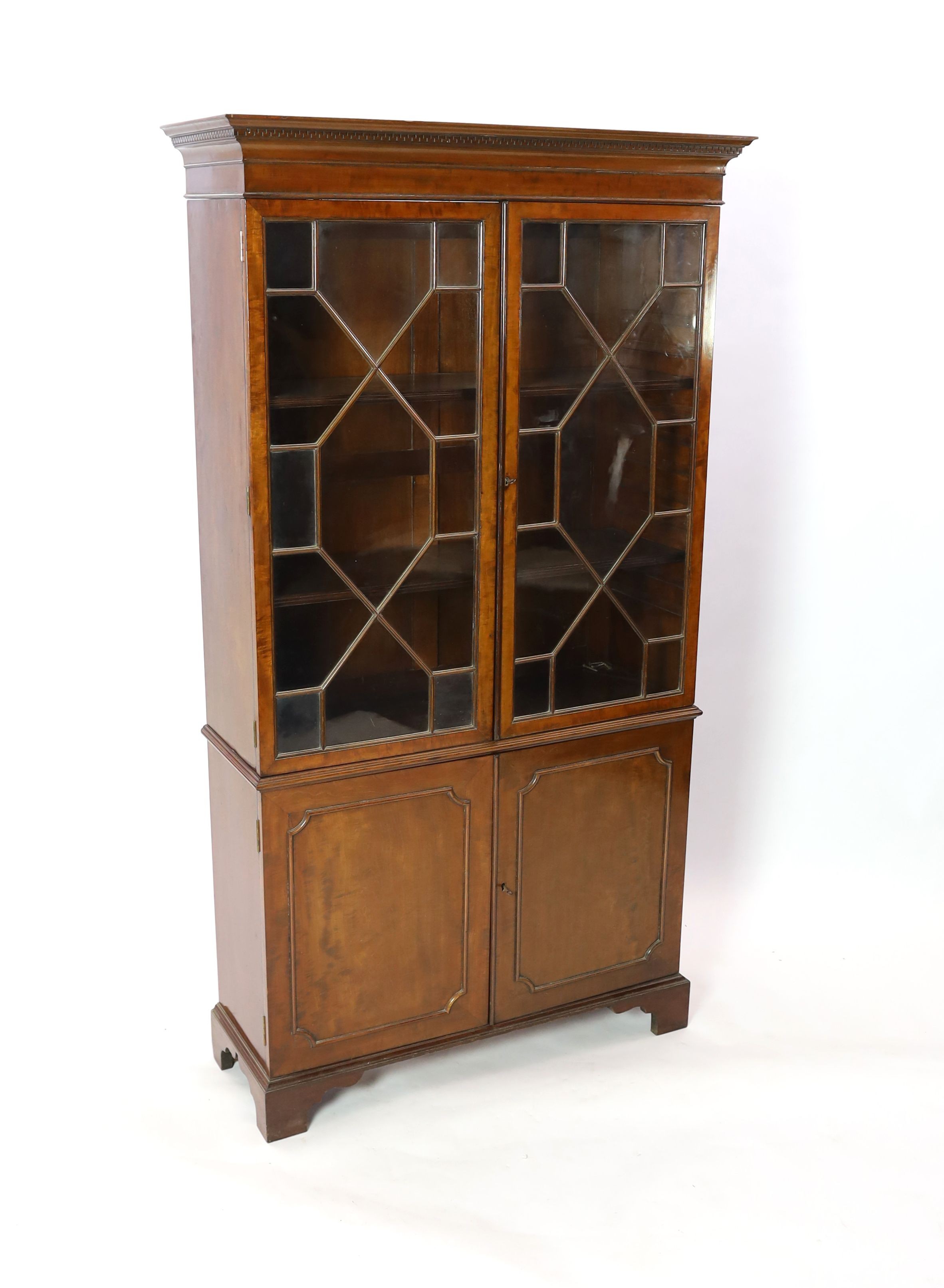 A reproduction George III style mahogany bookcase cupboard, width 106cm depth 37cm height 192cm